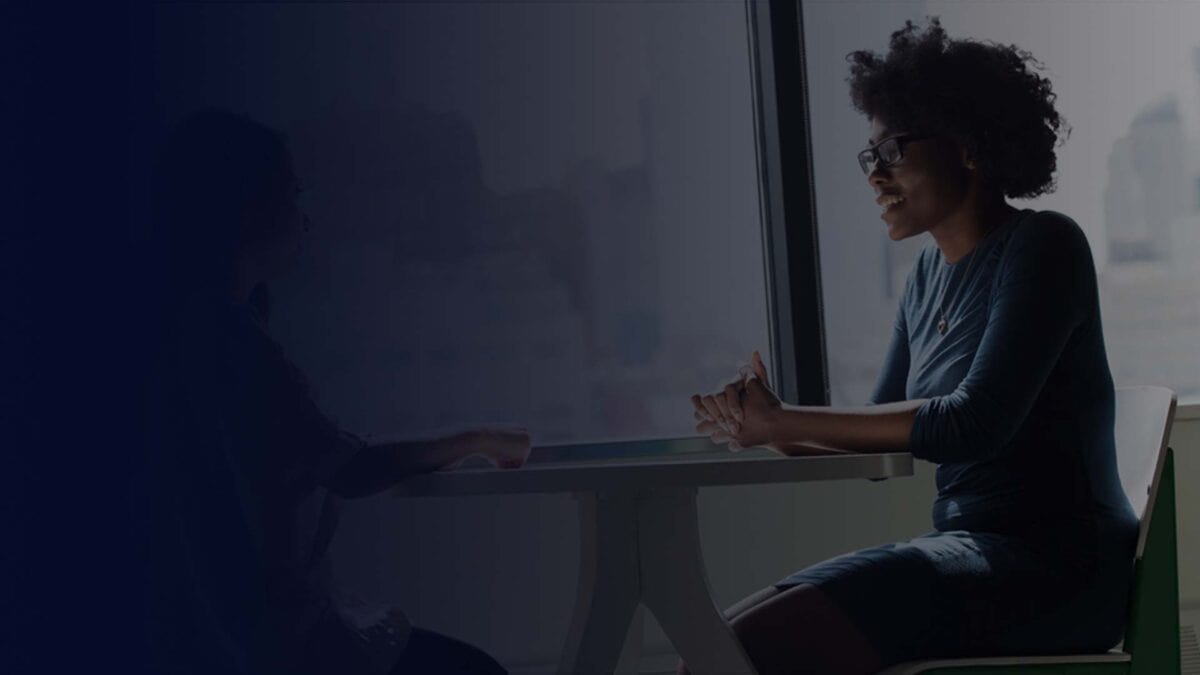 Professional working at a desk in a dark technology workspace