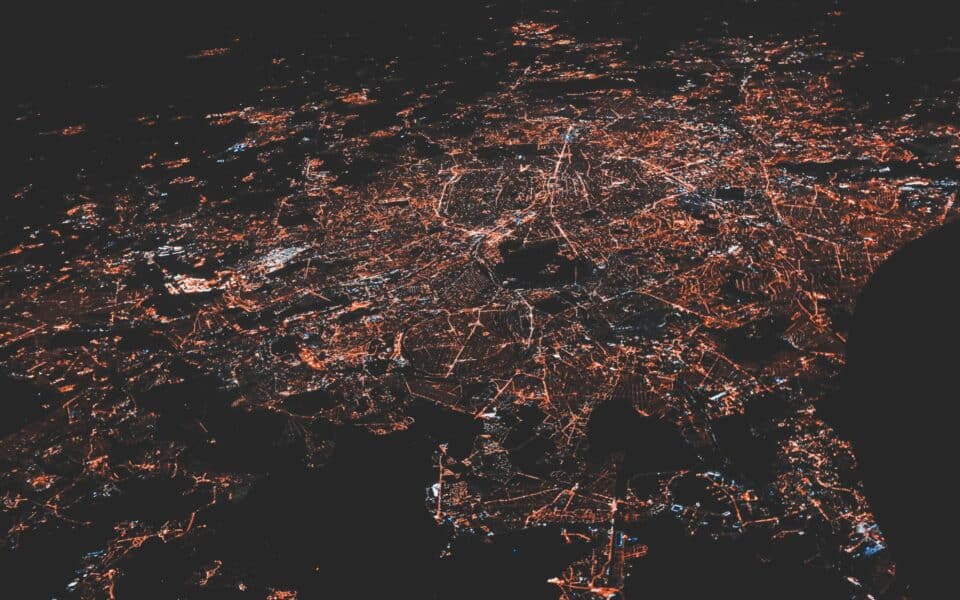 Aerial city lights forming a connected digital network at night