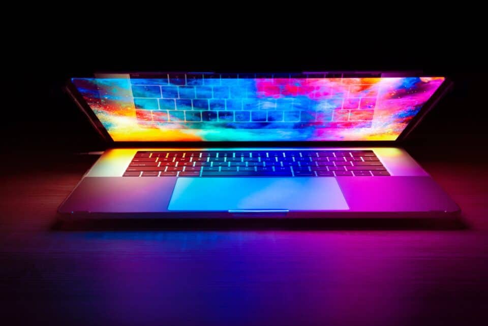 Close-up of a computer keyboard illuminated with colourful lights