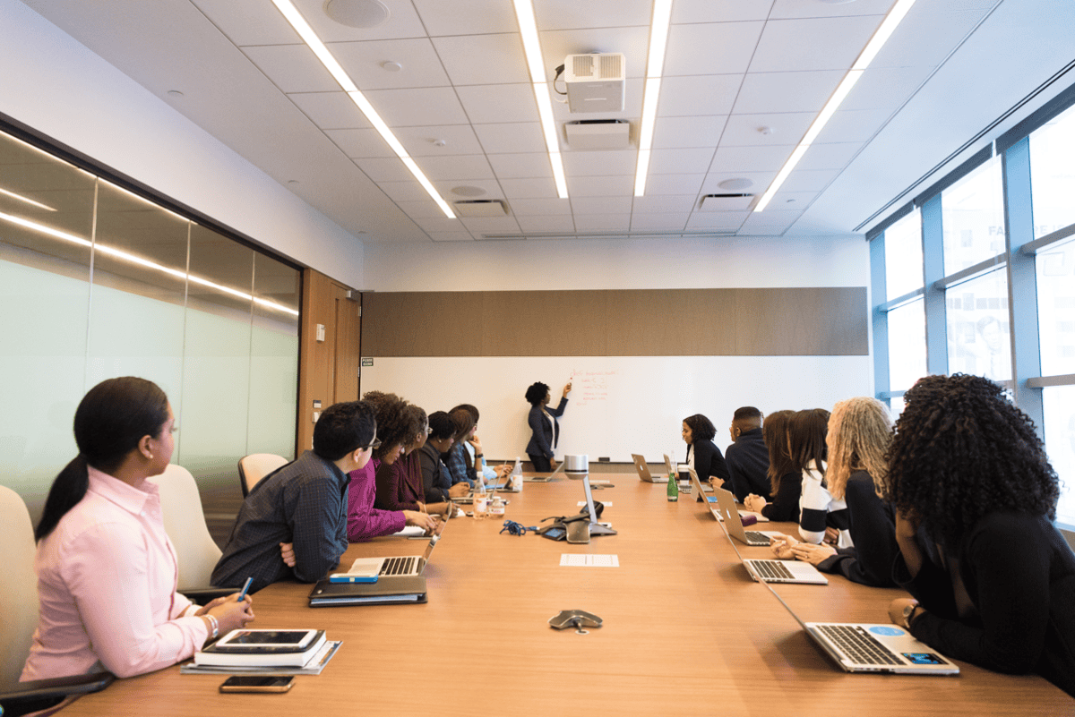 Professionals discussing recruitment work around a conference table