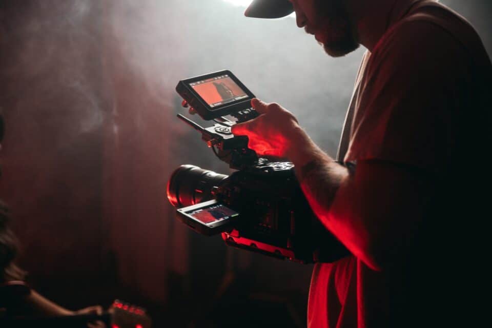 Person using a smartphone and compact equipment for digital content production
