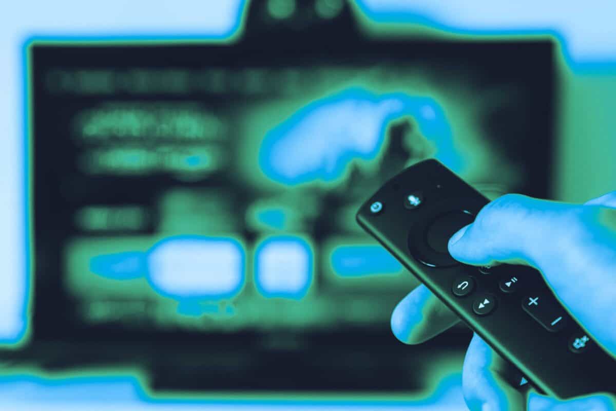 Smartphone held against a glowing digital technology background