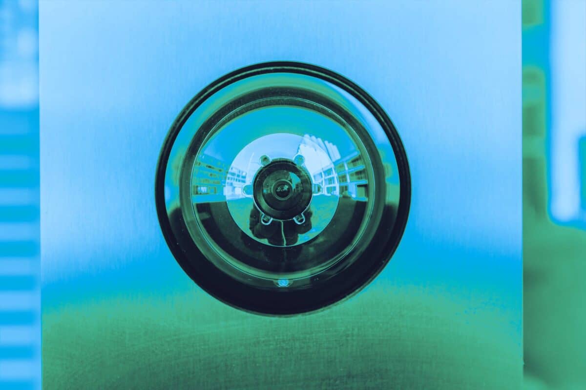 Circular camera lens representing surveillance and digital security technology