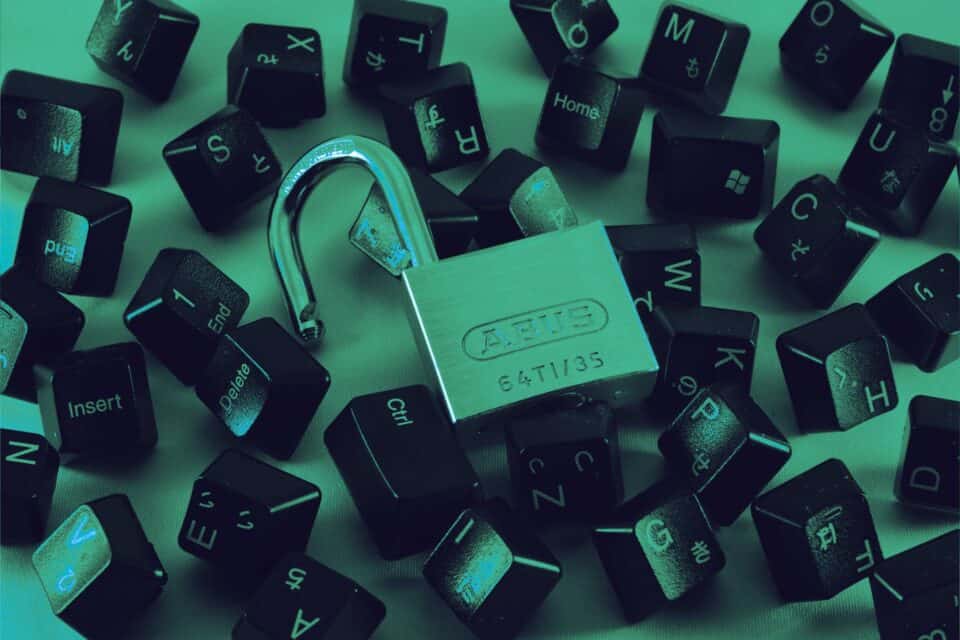 Close-up of computer keyboard keys in green cyber security lighting