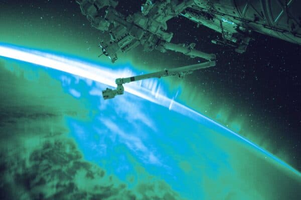 Satellite with solar panels orbiting above the Earth