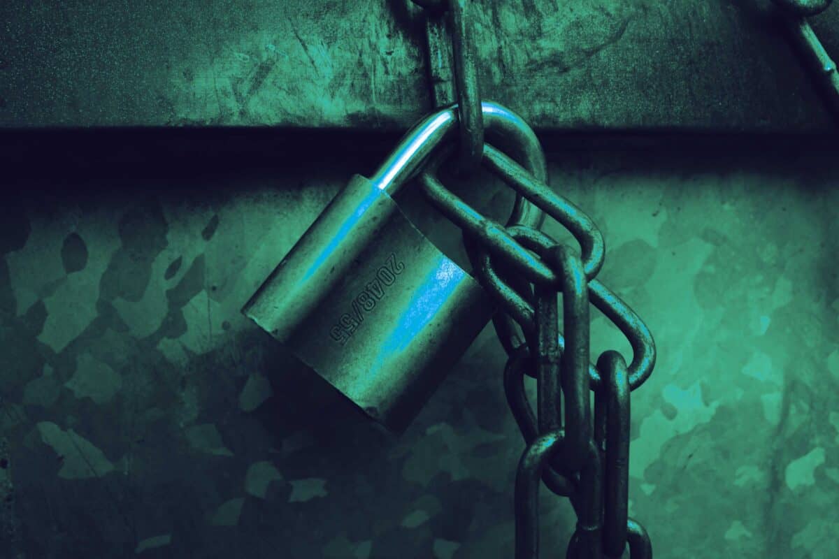 Closed padlock on a dark background representing digital security