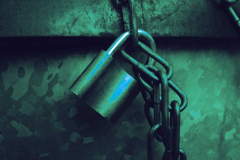 Closed padlock on a dark background representing digital security