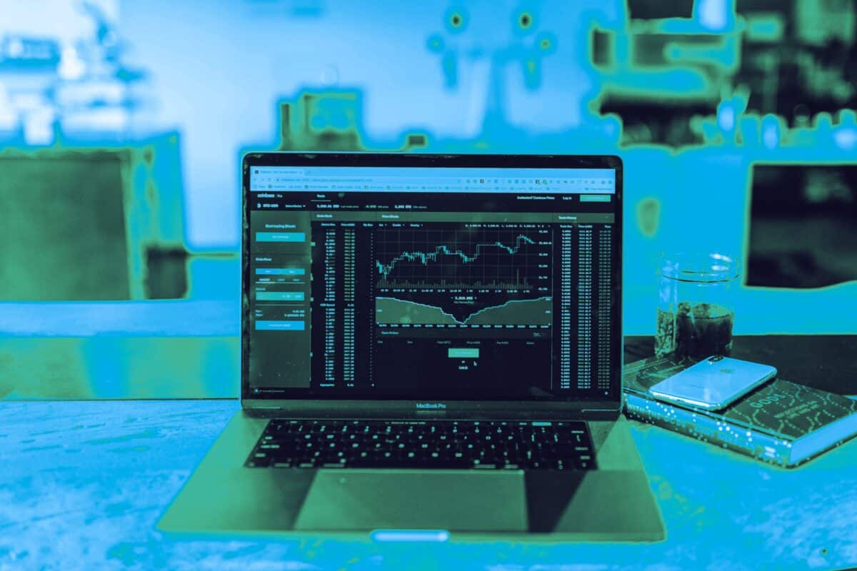 Laptop and monitors displaying data in a cyber security workspace