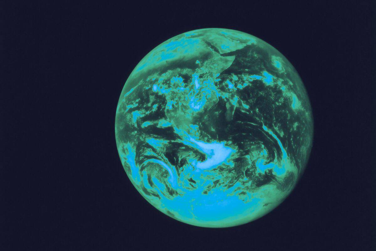 Planet Earth glowing against darkness in a satellite technology scene