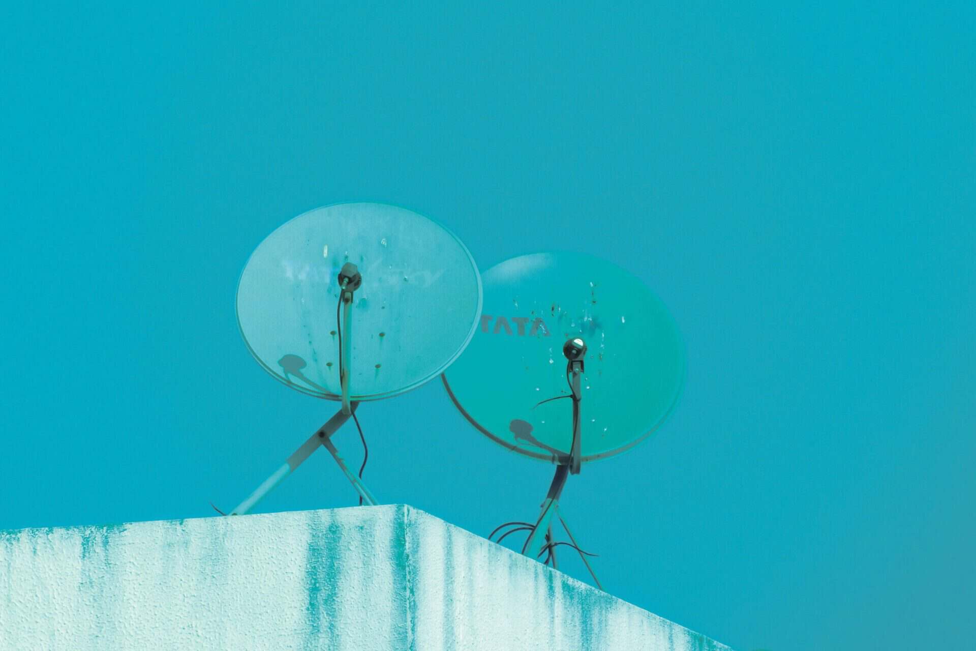 Satellite dish against a blue background representing content distribution
