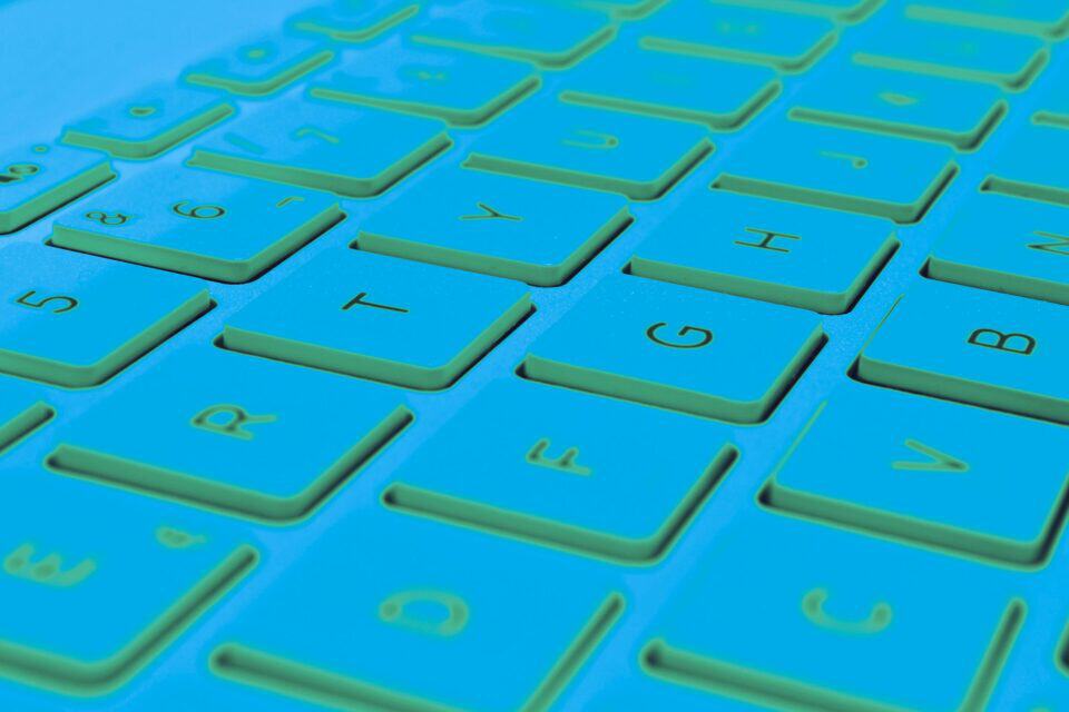 Close-up of keyboard keys illuminated in a cyber security setting