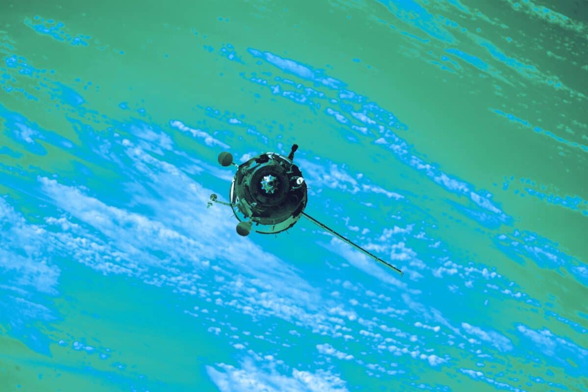 Satellite communications spacecraft travelling above the curved Earth