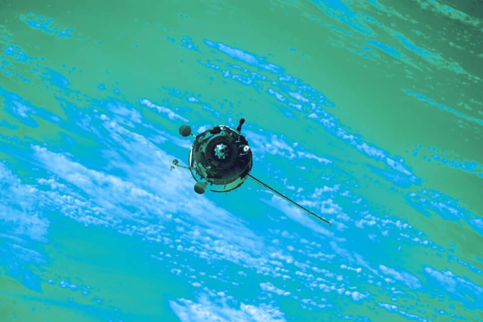 Satellite communications spacecraft travelling above the curved Earth