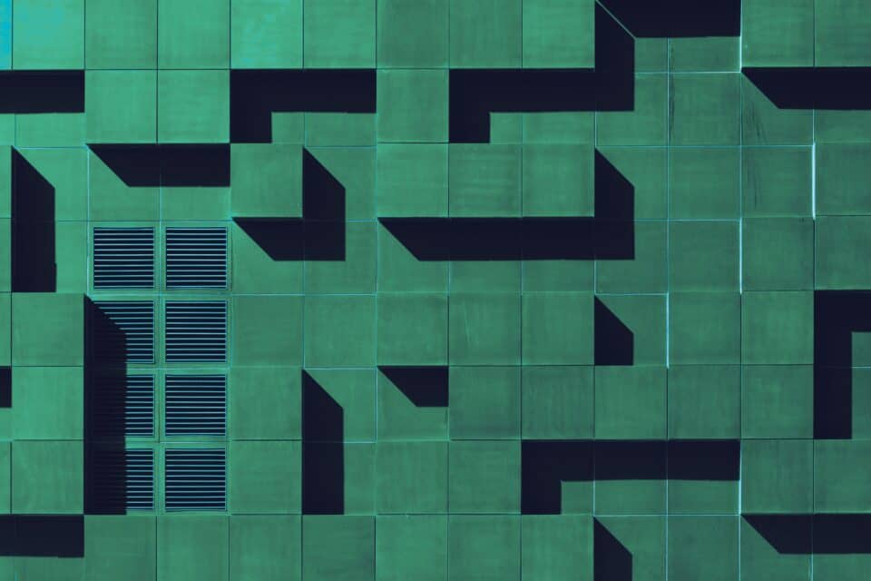 Dark green geometric blocks forming an abstract cyber security pattern