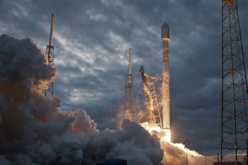 Rocket launching through clouds on a satellite mission