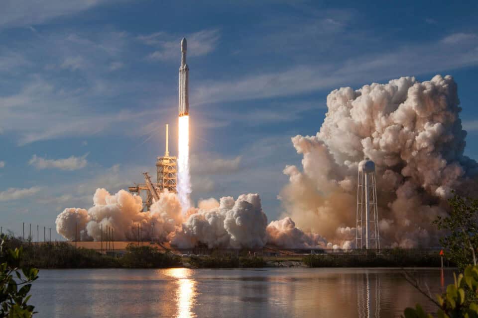 Rocket launching through clouds on a satellite mission