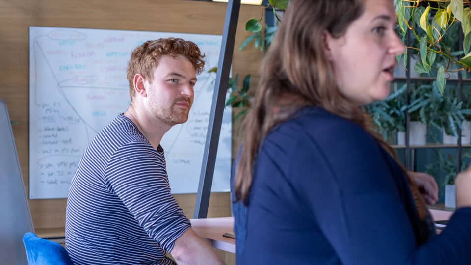 Two Neuco Group colleagues discussing work in the office