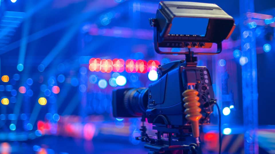 Production equipment and colourful lights in a broadcast media studio