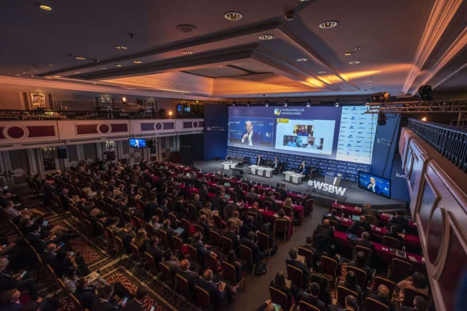 Visitors exploring stands inside a busy technology exhibition hall