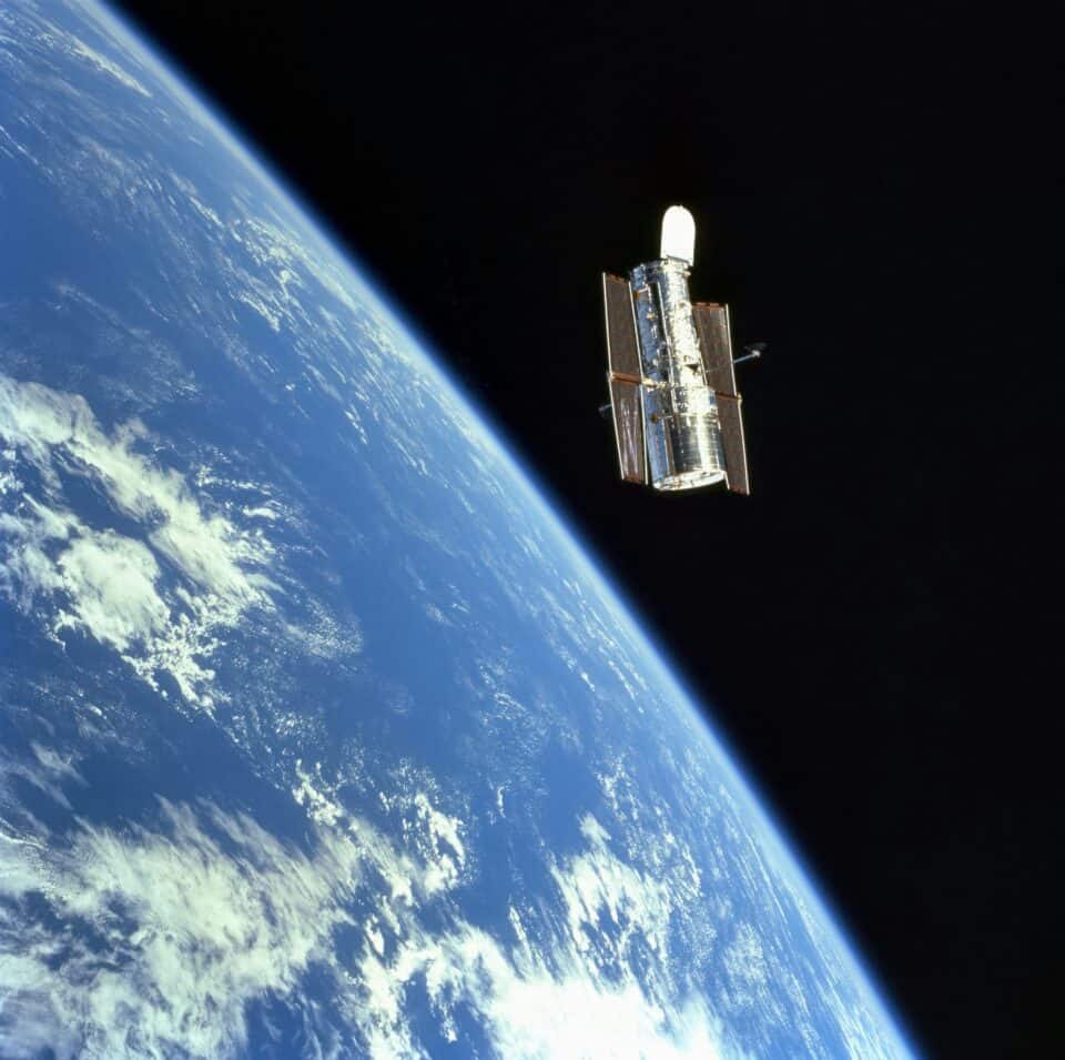 NASA Hubble Space Telescope orbiting above the curved Earth