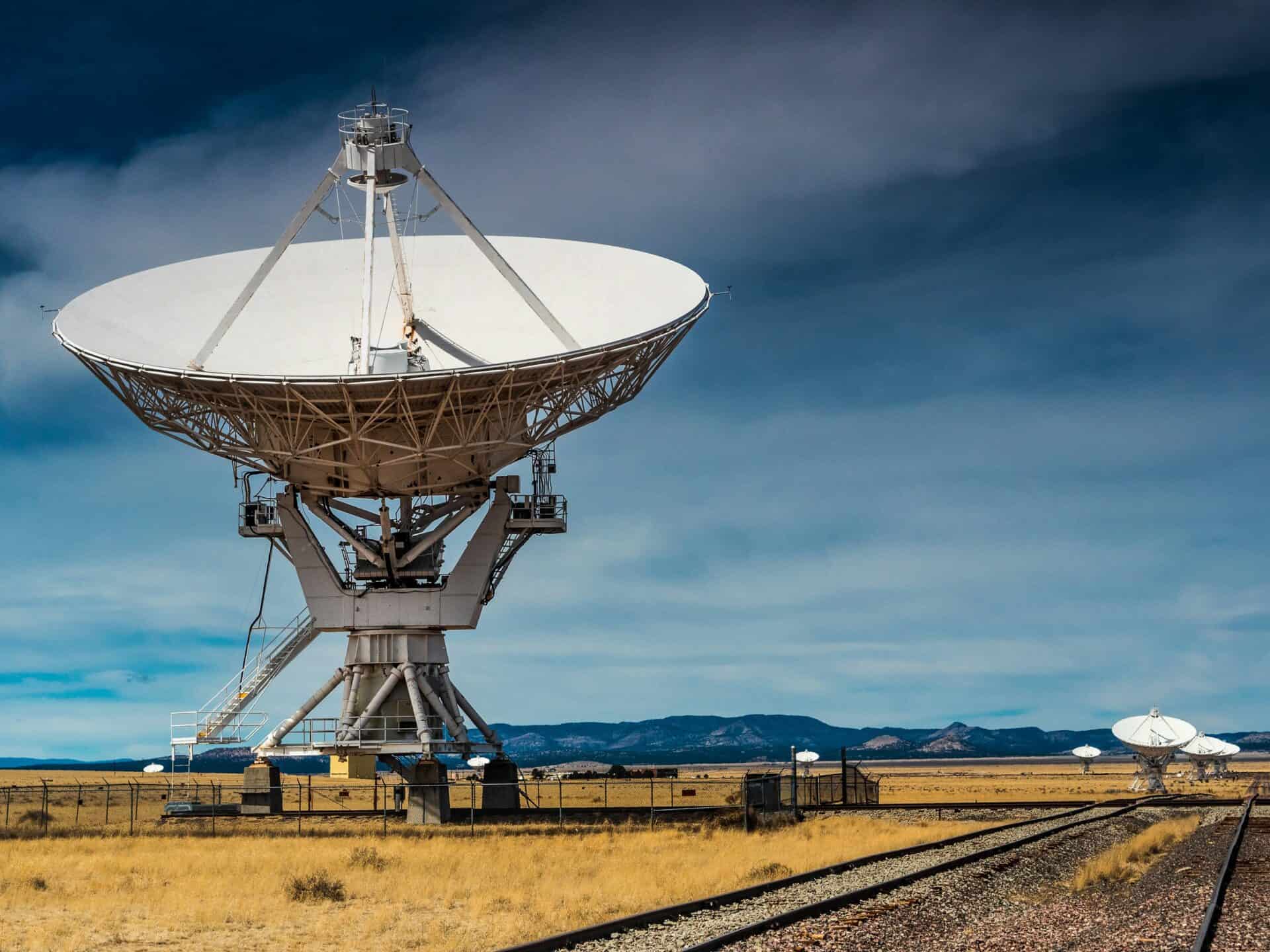 Large satellite dish supporting global connectivity under a cloudy sky